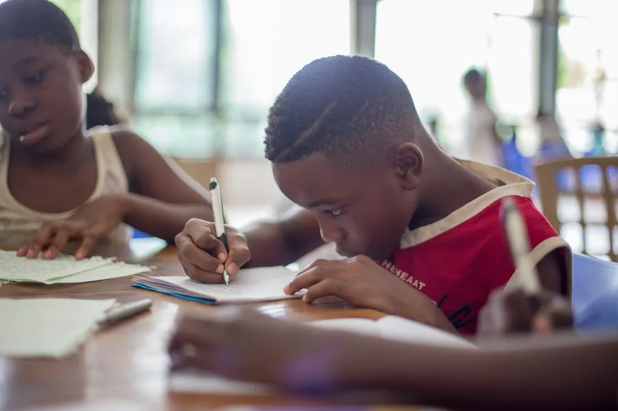 Children focused on learning and writing in class